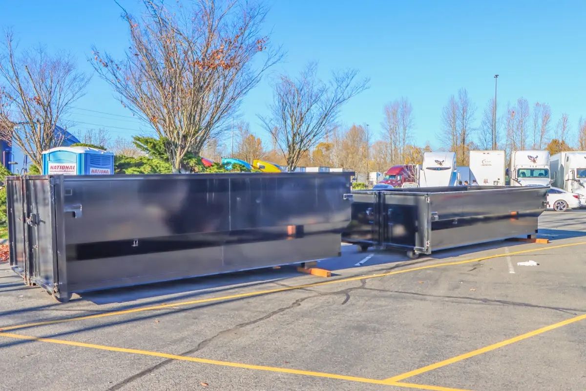 Professional dumpster rental service with roll-off container on residential driveway in Kissimmee